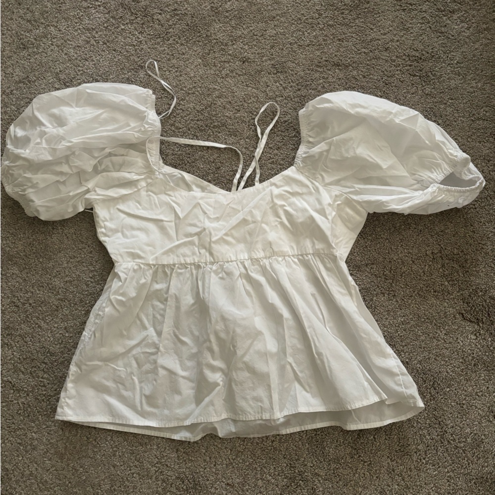 White top, flowy bottom, puffy sleeves, tight bra with two adjustable strings